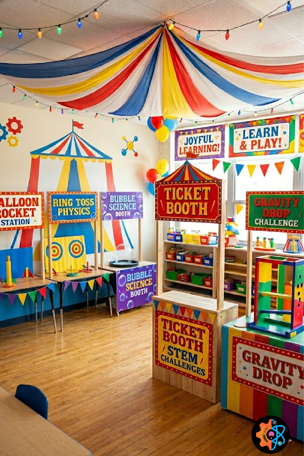 A vibrant elementary science classroom transformed into a STEM carnival theme with a colorful fabric ceiling canopy and interactive learning booths.